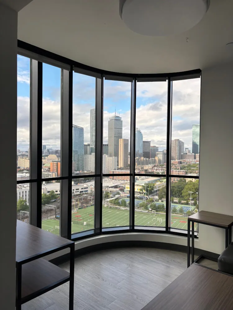 Furnished bedroom in luxury Boston apartment with skyline view