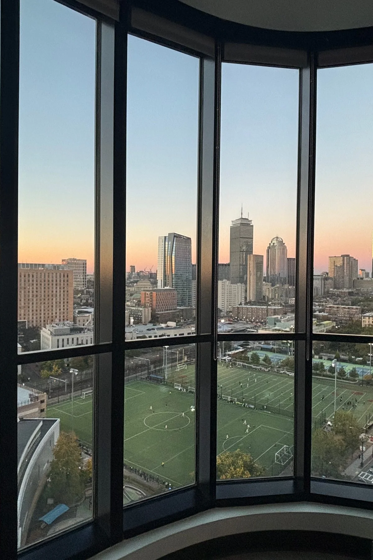 Furnished bedroom in luxury Boston apartment with skyline view